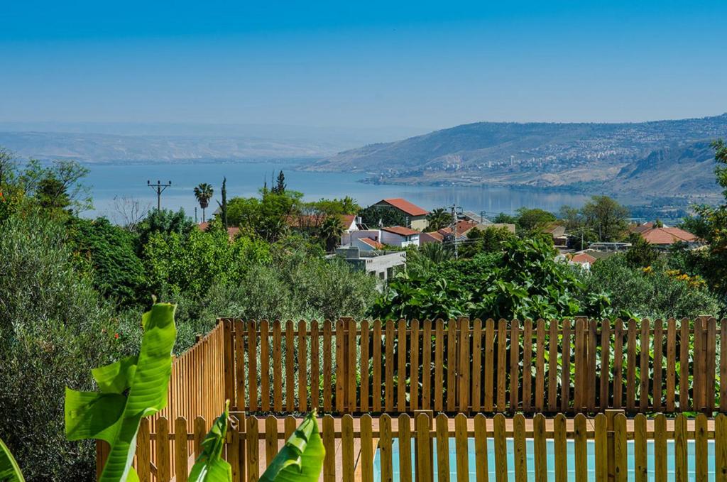 a wooden fence with a view of the water at Nof Tzameret Cabins in Kahal