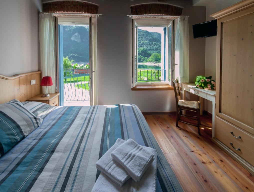 Postel nebo postele na pokoji v ubytování Albergo Parigi