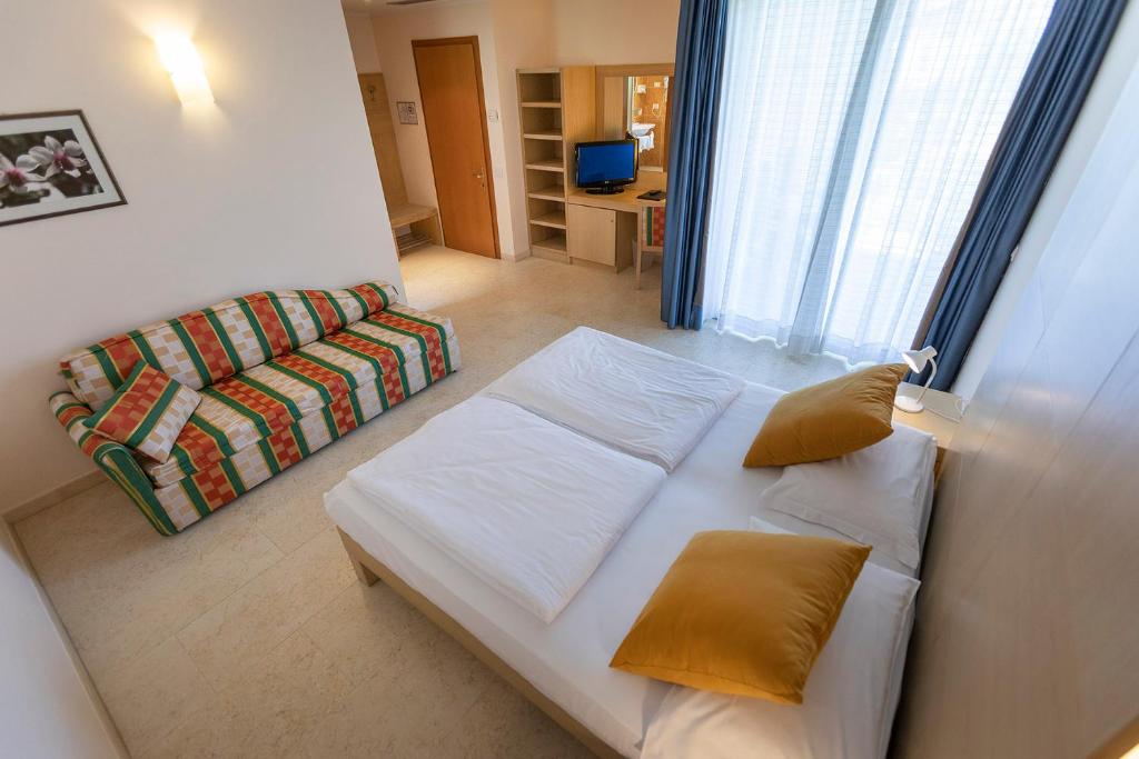 Postel nebo postele na pokoji v ubytování Hotel Garnì Orchidea