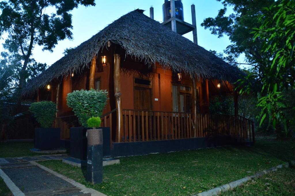 a small church with a thatch roof at The Bell Farm Eco Resort in Sigiriya