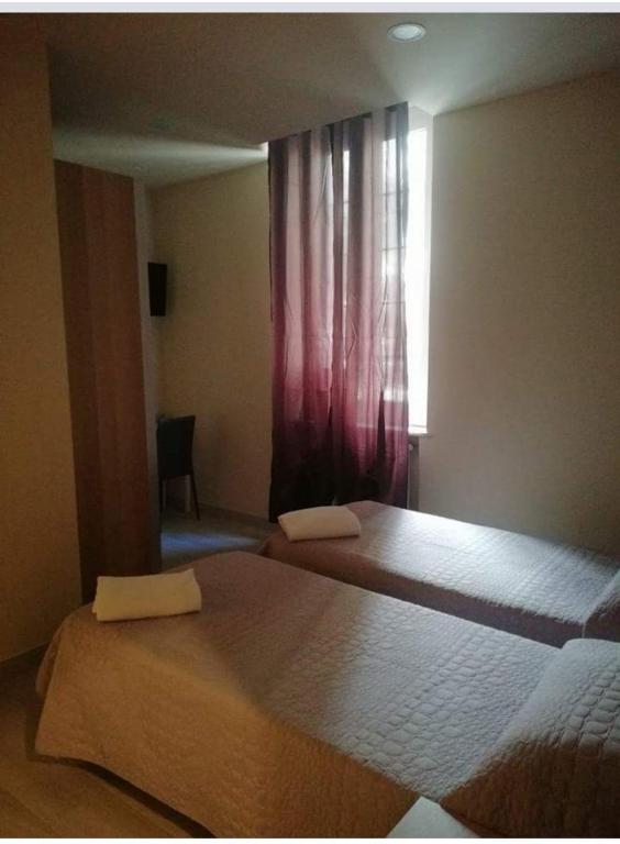 A bed or beds in a room at Albergo Torino