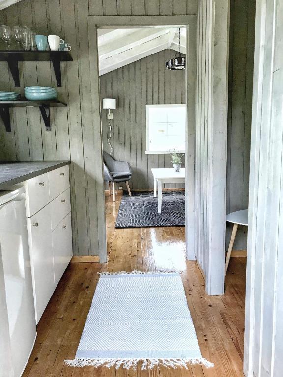 a kitchen with a table and a white rug at Solbakken Cabins in Geiranger