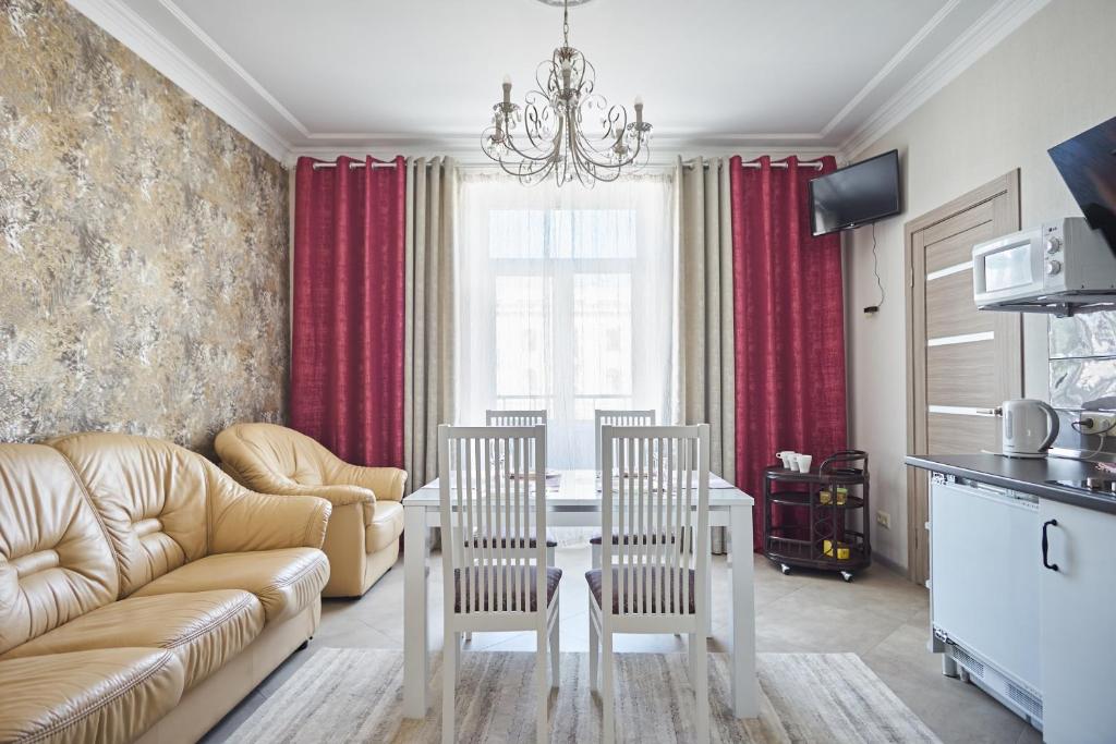 a living room with a couch and a table and chairs at Studiominsk 9 Apartments in Minsk