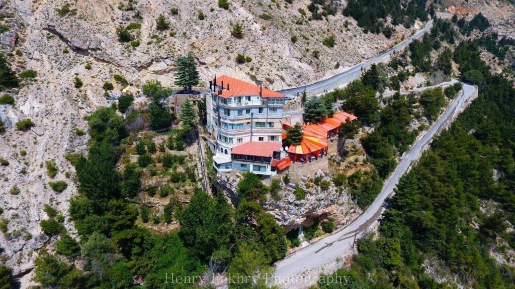 an aerial view of a house on a mountain at Hotel L'Aiglon in Bcharré