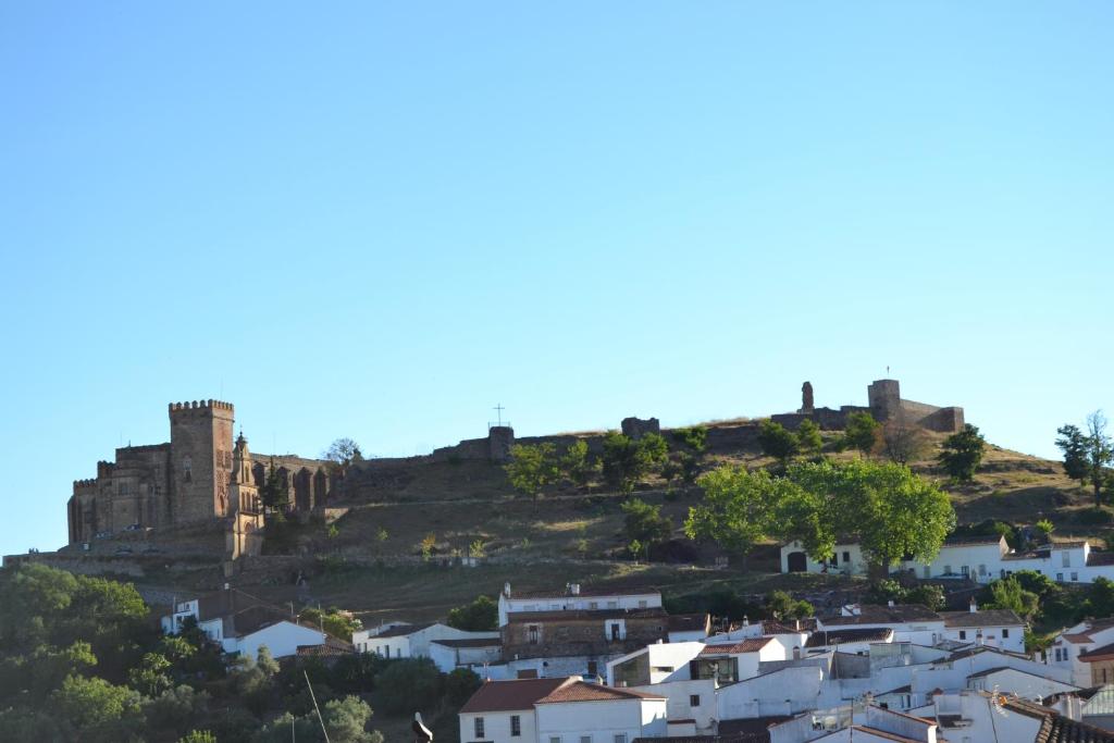 a castle on top of a hill with houses at Casa Torrubia in Aracena