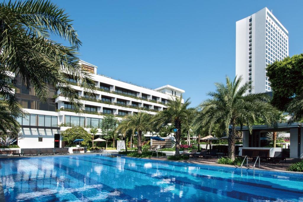 a swimming pool in front of a building at White Swan Hotel in Guangzhou