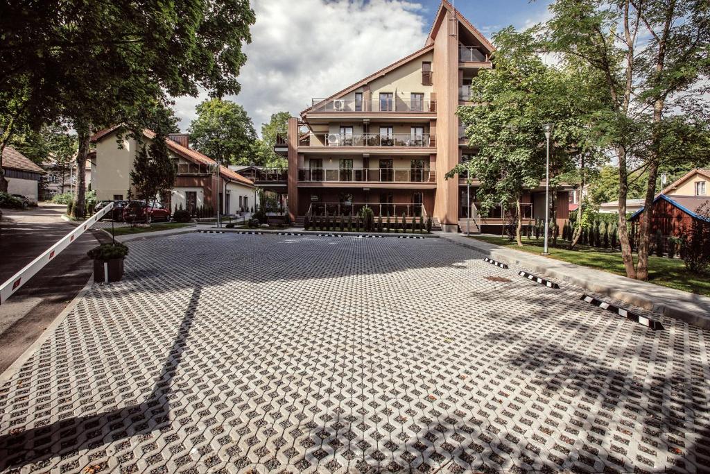 un gran edificio con una calle adoquinada delante de él en "Comfort Stay" - Juodkrante, en Juodkrantė