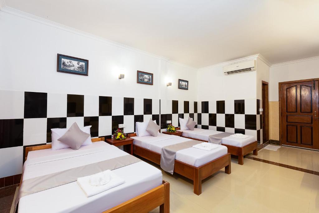 Ένα ή περισσότερα κρεβάτια σε δωμάτιο στο Botoum Hostel
