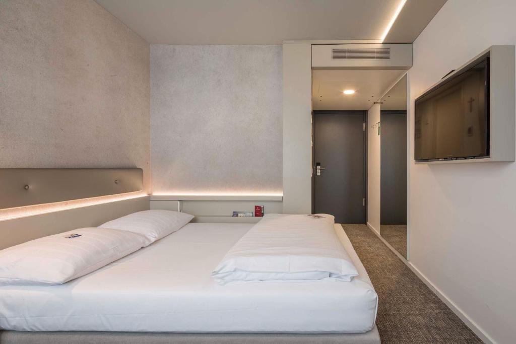 Postel nebo postele na pokoji v ubytování Stadthotel Münster