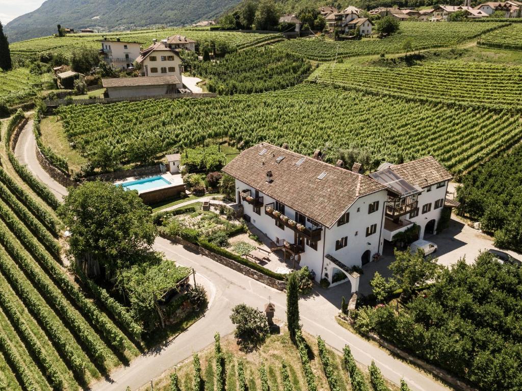 an aerial view of a house in a vineyard at Weingut Weidlhof - Suite & Breakfast - Vacation for wine lovers in Caldaro