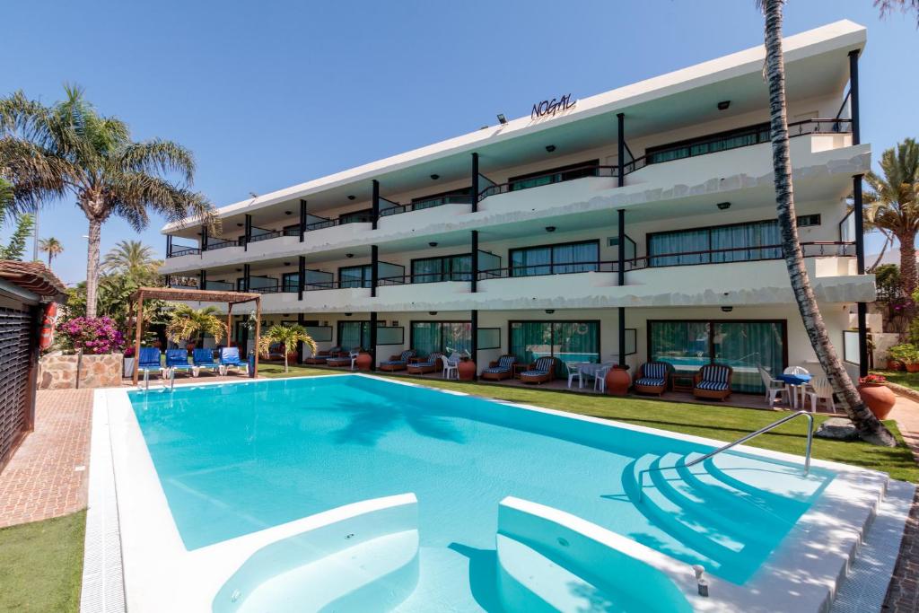 a swimming pool in front of a building at VIP Apartamentos Nogal- Adults Only in Playa del Ingles