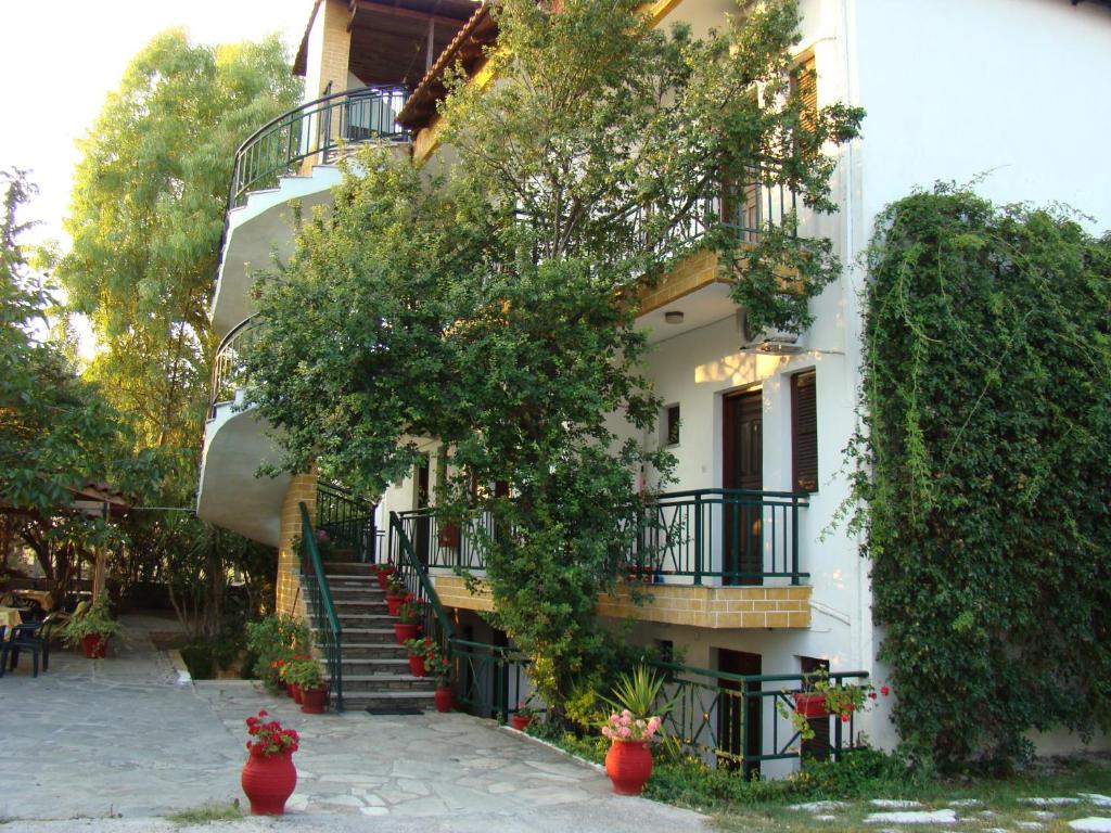 a building with stairs and ivy on the side of it at Panorama in Kallithea Halkidikis