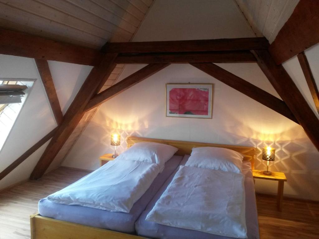 a bedroom with two beds in a attic at Ferienwohnung Familie Faath in Bellheim