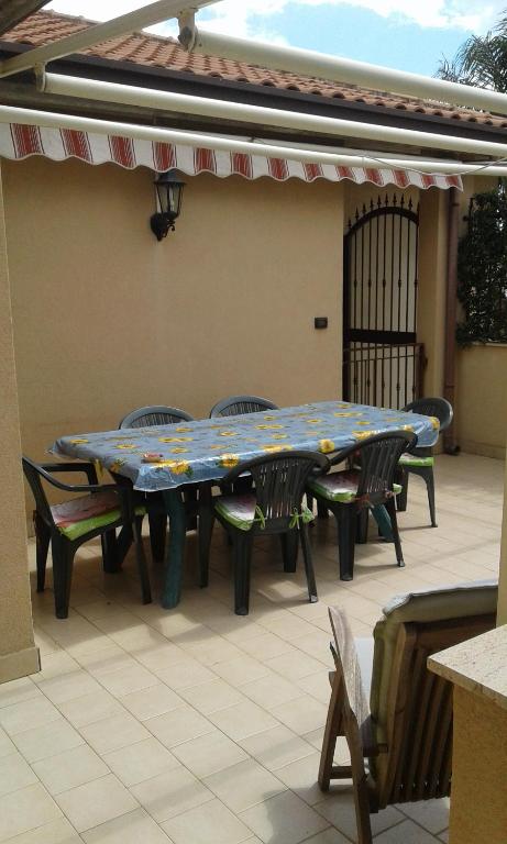 a table and chairs sitting on a patio at prato del mare 1 in Catania