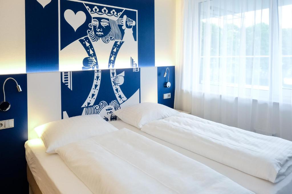 Postel nebo postele na pokoji v ubytování Aparthotel Paderborn