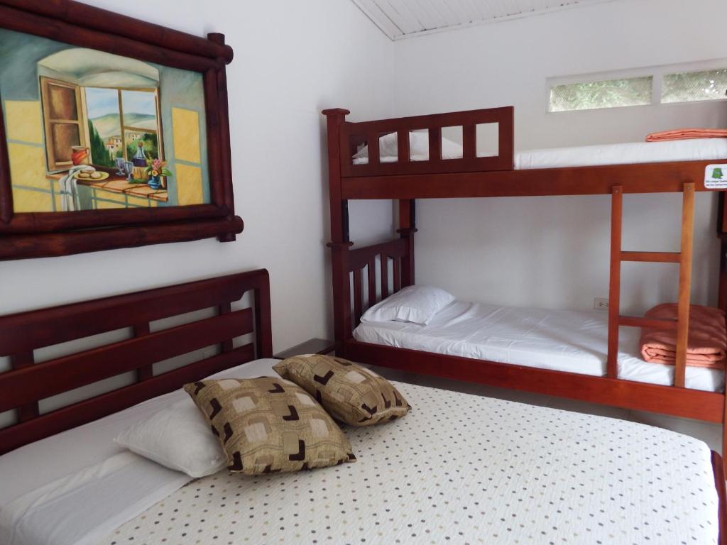 Postel nebo postele na pokoji v ubytování Hotel Campestre Villa Yudy