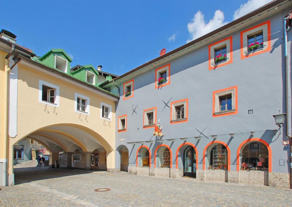 a large building with an archway in a street at „Alte Fronfeste“ Berchtesgaden in Berchtesgaden