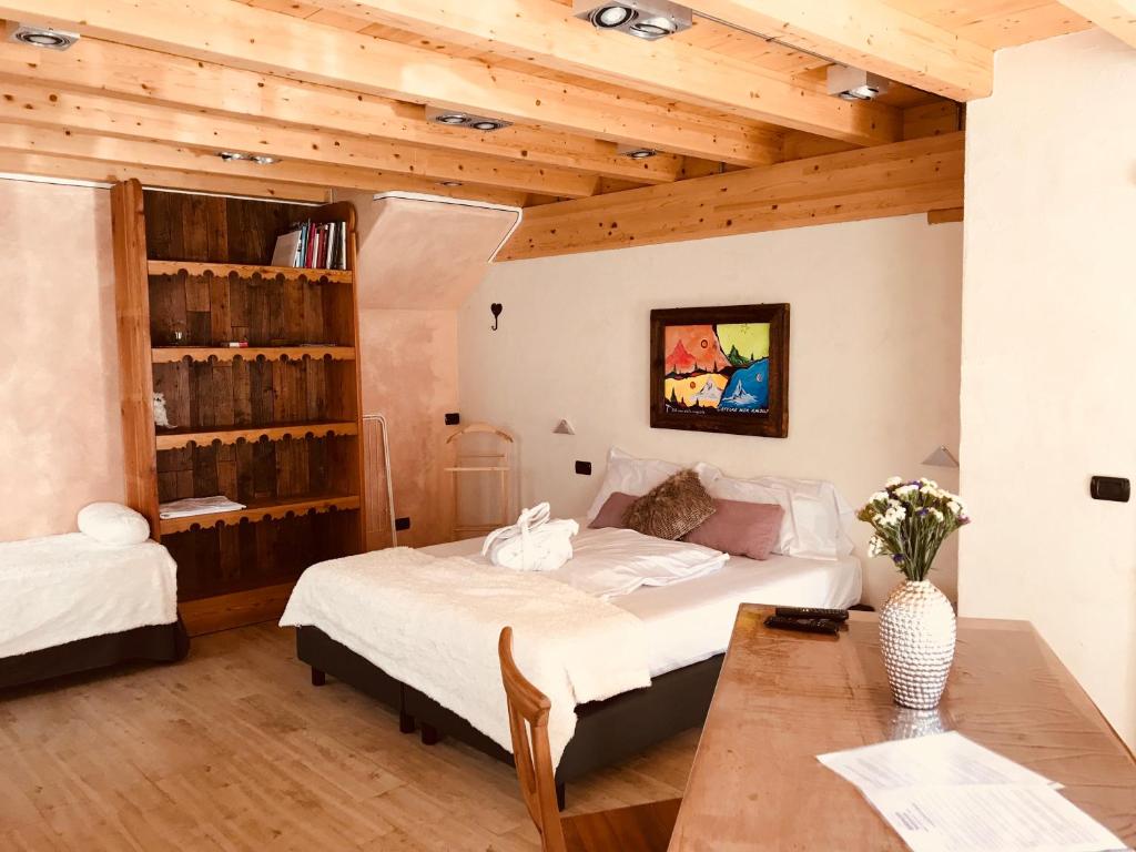 1 dormitorio con cama y techo de madera en B&B Balançon Mountain Lodge en Torgnon