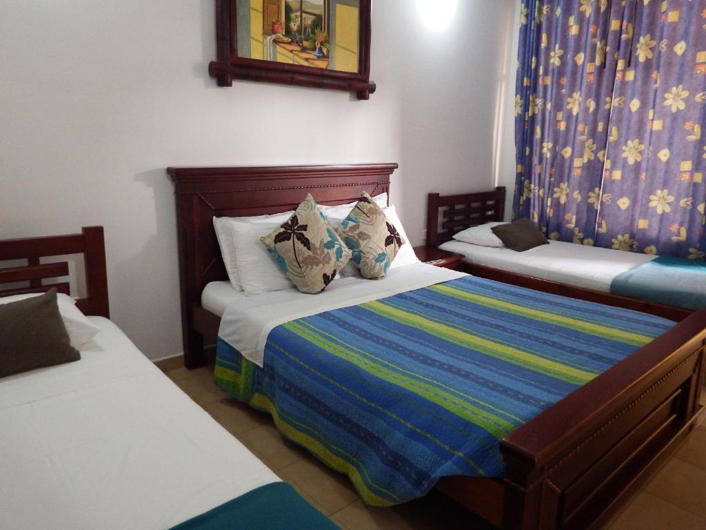 Postel nebo postele na pokoji v ubytování Hotel Campestre Villa Yudy