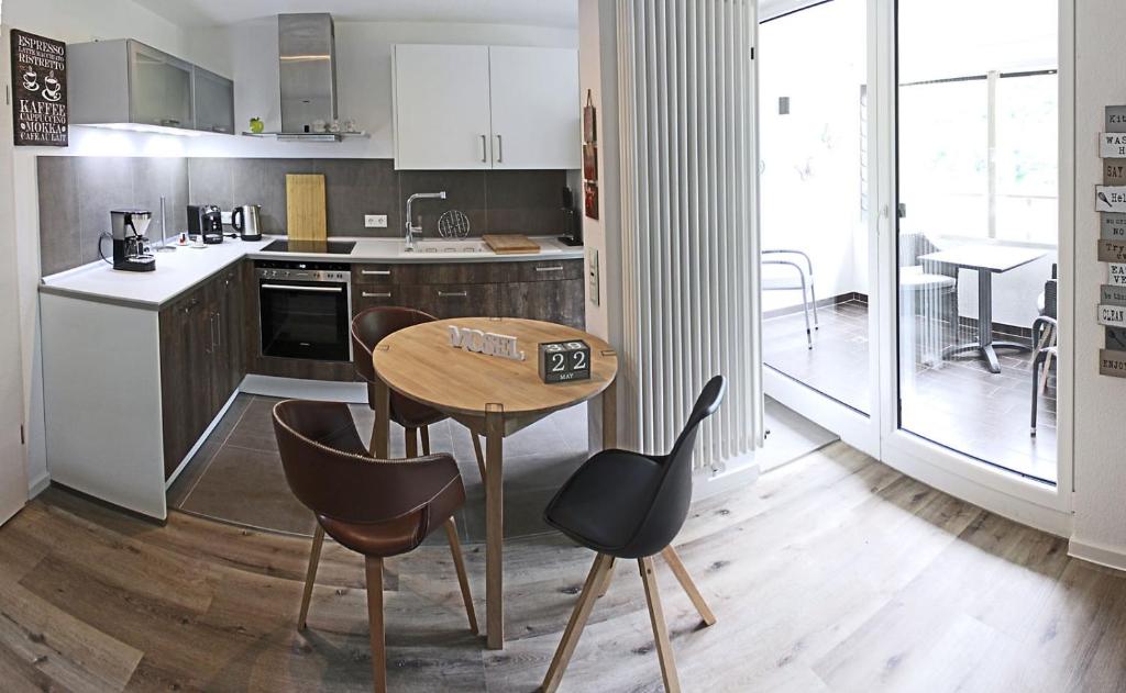 a kitchen with a table and chairs and a table at Haus Josef Klotten Wohnung 2 in Klotten