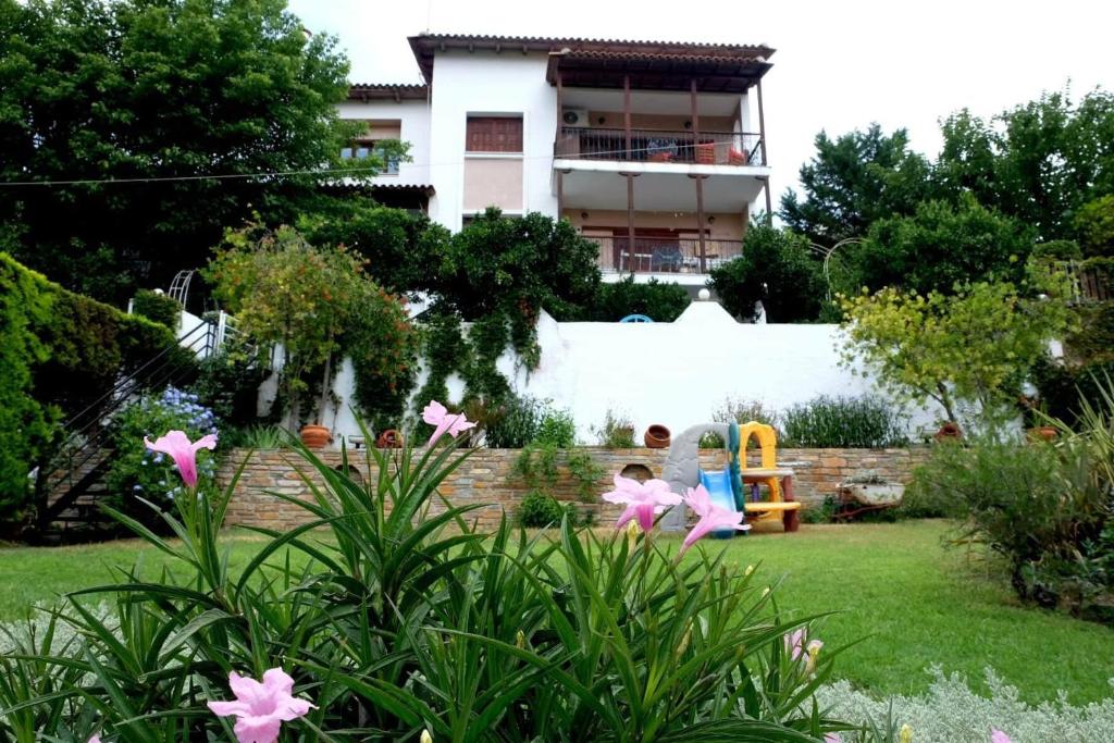 a child playing in a garden with a playground at Villa Sofia in Marathos