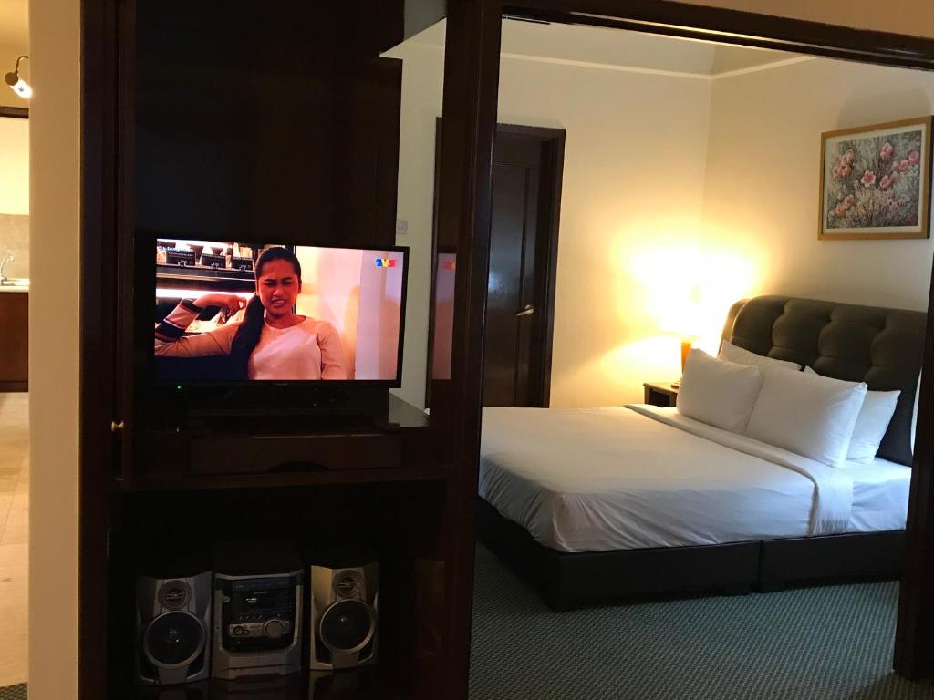 Ein Bett oder Betten in einem Zimmer der Unterkunft KL Service Suites at Times Square KL