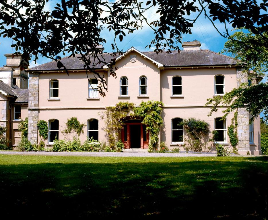 a large white house with a green lawn at Rossnaree House in Slane