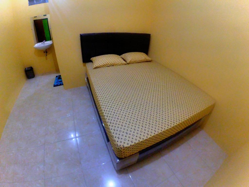 Postel nebo postele na pokoji v ubytování Nitha Homestay