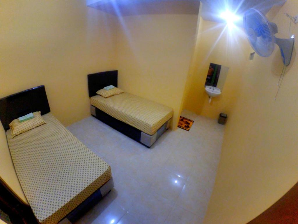 Postel nebo postele na pokoji v ubytování Nitha Homestay