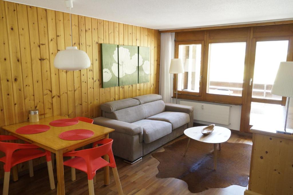 a living room with a couch and a table at Monte Rosa D 412 in Täsch