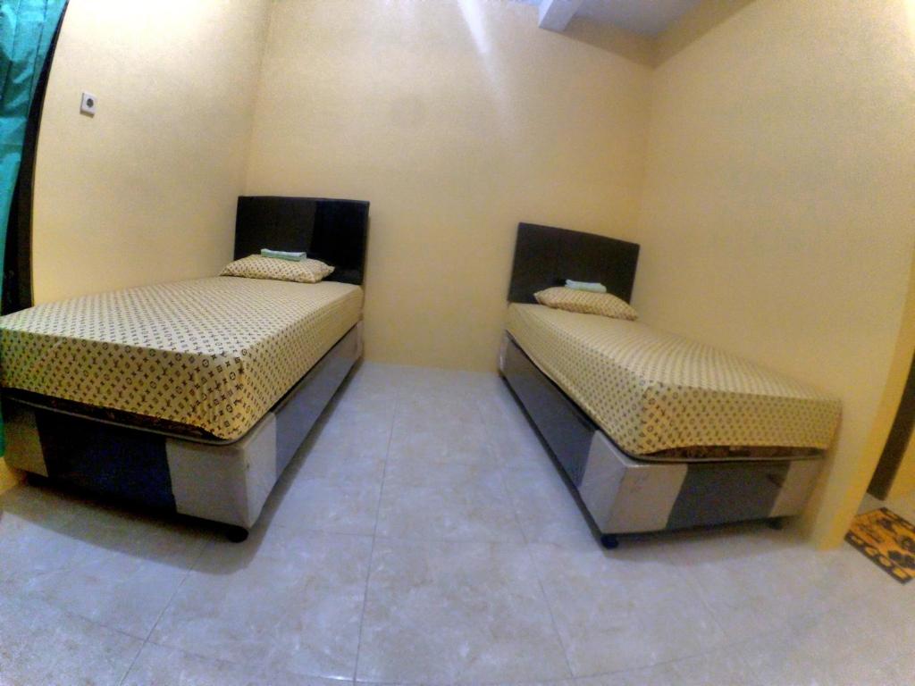 Postel nebo postele na pokoji v ubytování Nitha Homestay