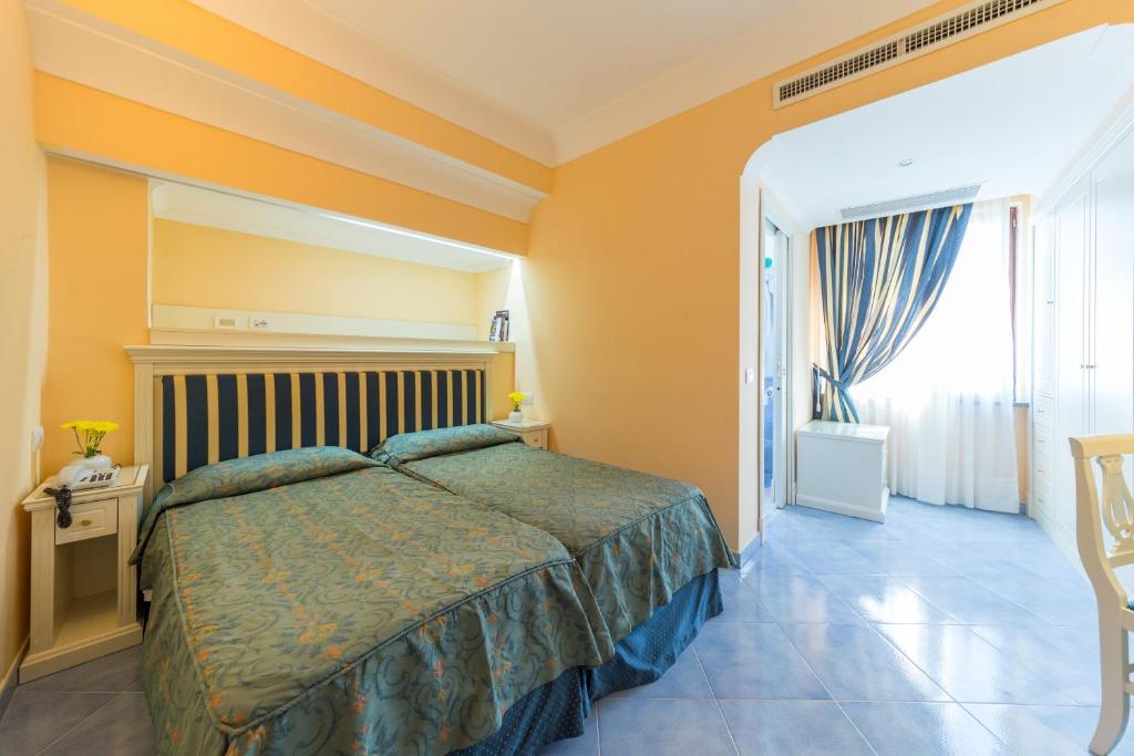 Posteľ alebo postele v izbe v ubytovaní Hotel Iaccarino
