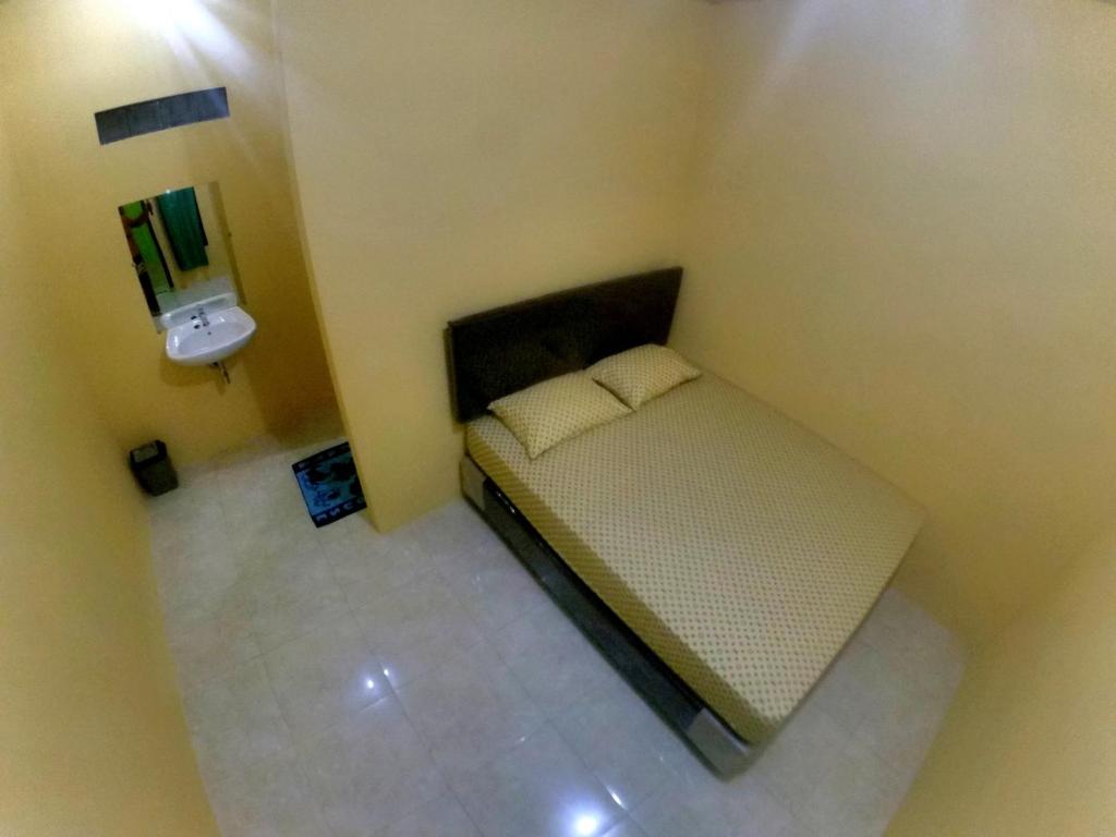 Postel nebo postele na pokoji v ubytování Nitha Homestay