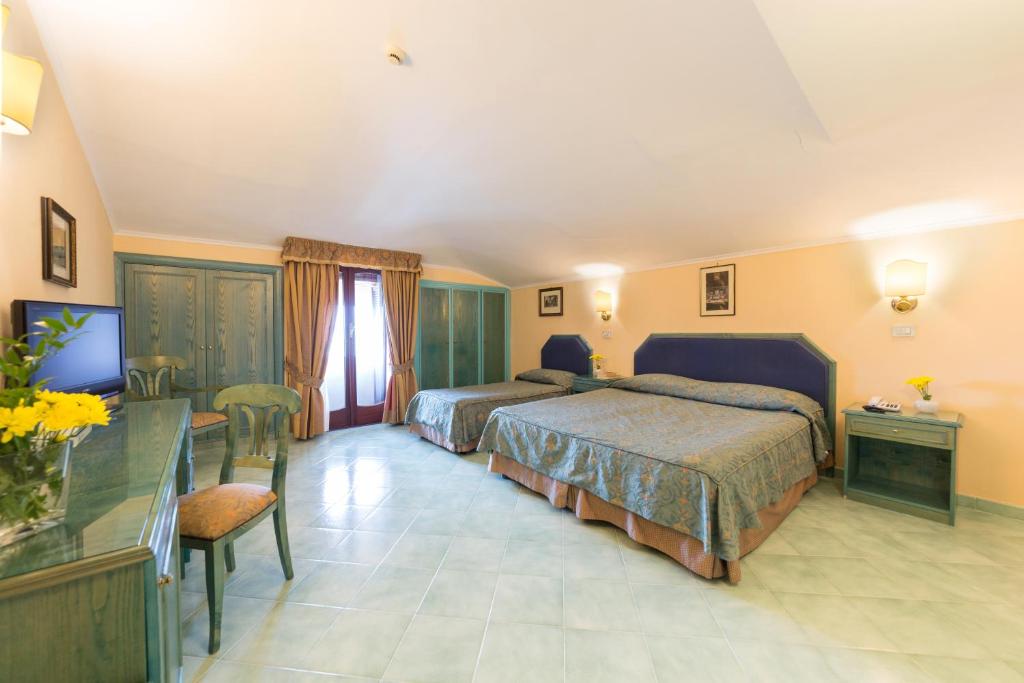 Posteľ alebo postele v izbe v ubytovaní Hotel Iaccarino