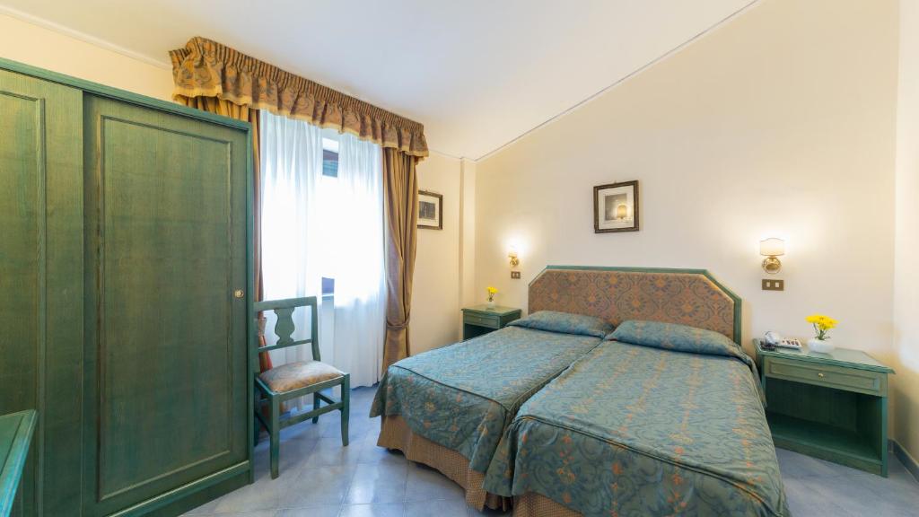 Posteľ alebo postele v izbe v ubytovaní Hotel Iaccarino
