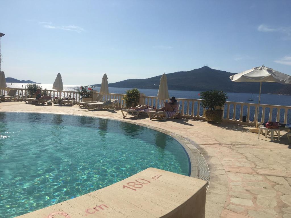 a swimming pool with a view of the water at Club Patara Villas 222 in Kalkan