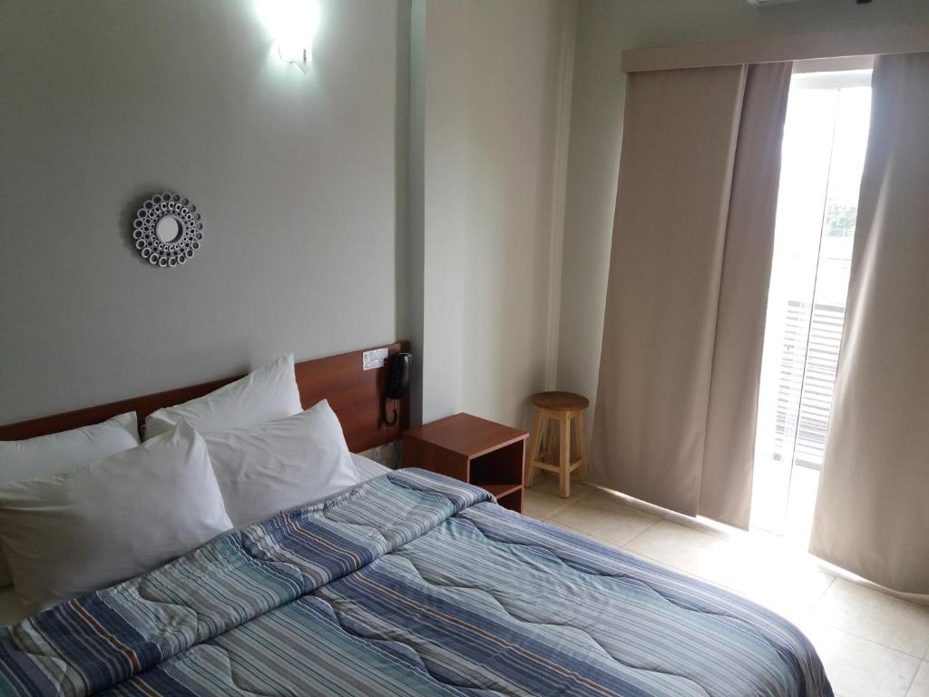 Postel nebo postele na pokoji v ubytování Madame Lynch Hotel Asuncion