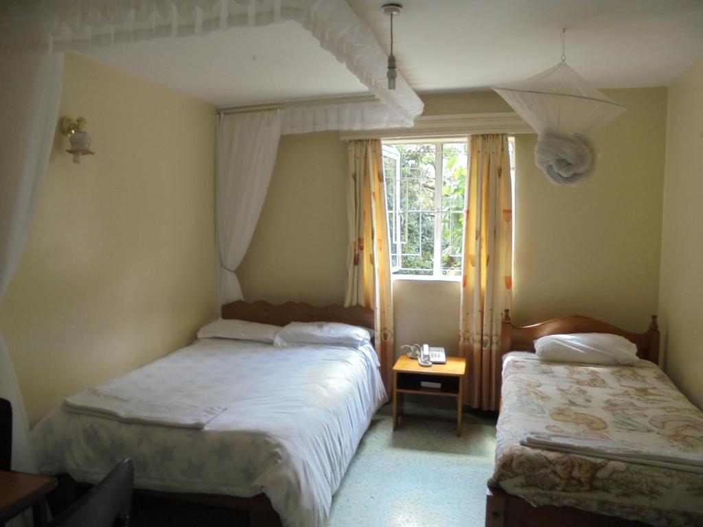 Postel nebo postele na pokoji v ubytování Adventist LMS Guest House & Conference Centre