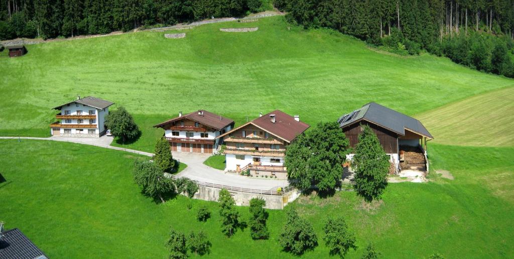 an aerial view of a house on a green field at Bahlerhof - Luxner Annelies in Ried im Zillertal