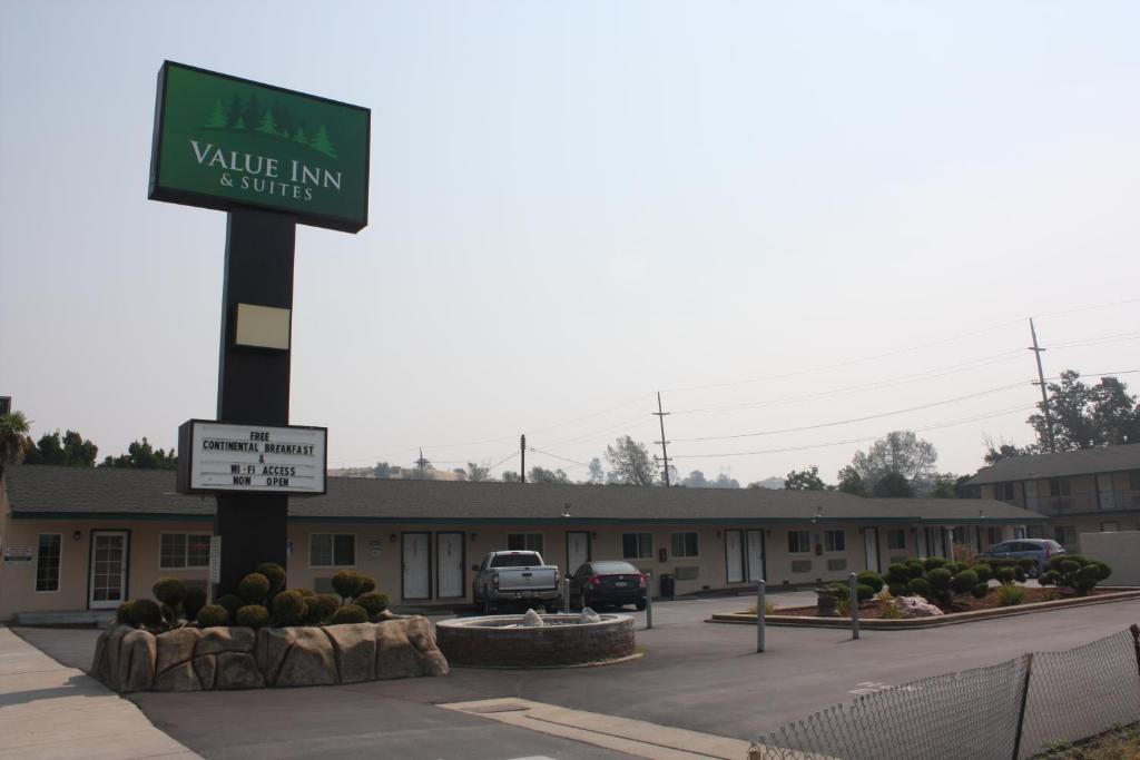 a parking lot with a sign for a valley inn suites at Value Inn & Suites in Redding