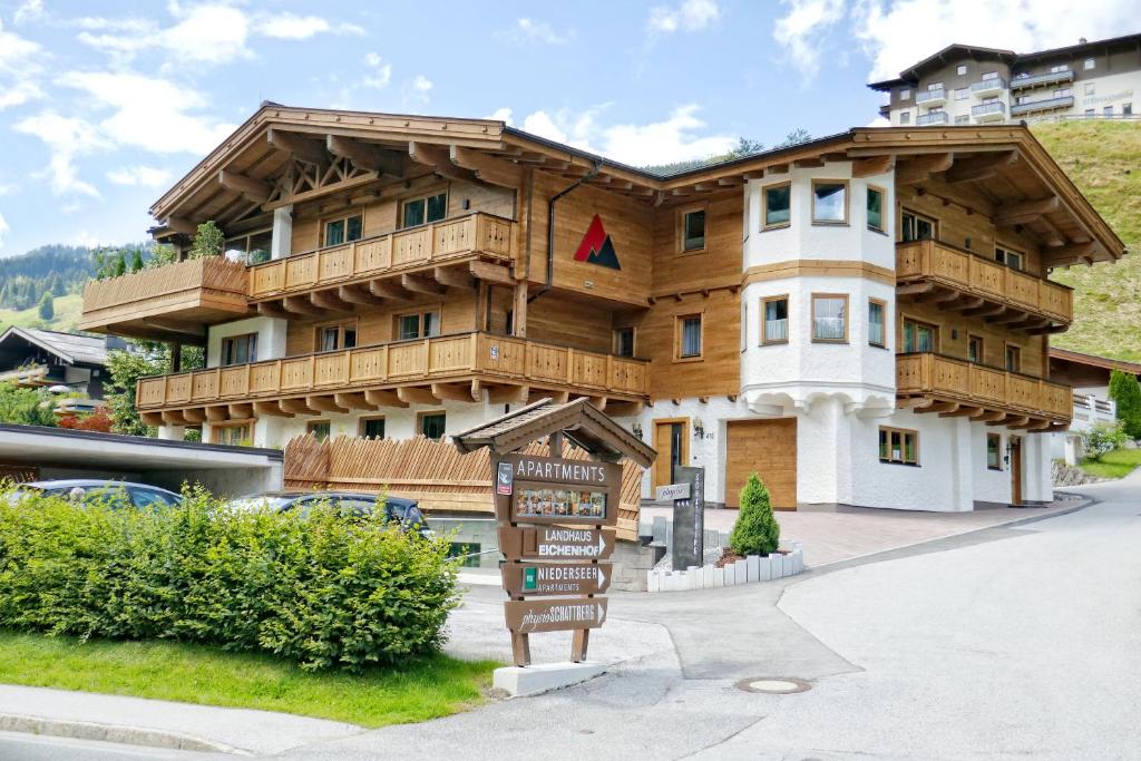 a large wooden building with a sign in front of it at Apartments Niederseer in Saalbach Hinterglemm