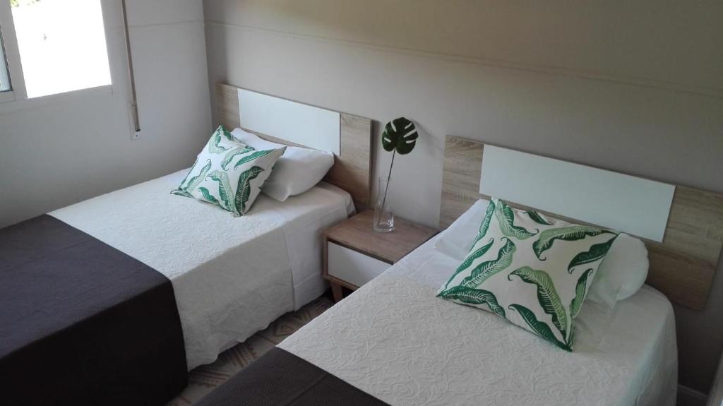 two beds in a small room with sidx sidx sidx sidx at Marvera in Caldas de Reis