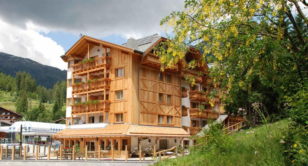 a large wooden building on the side of a mountain at Campiglio Bellavista in Madonna di Campiglio