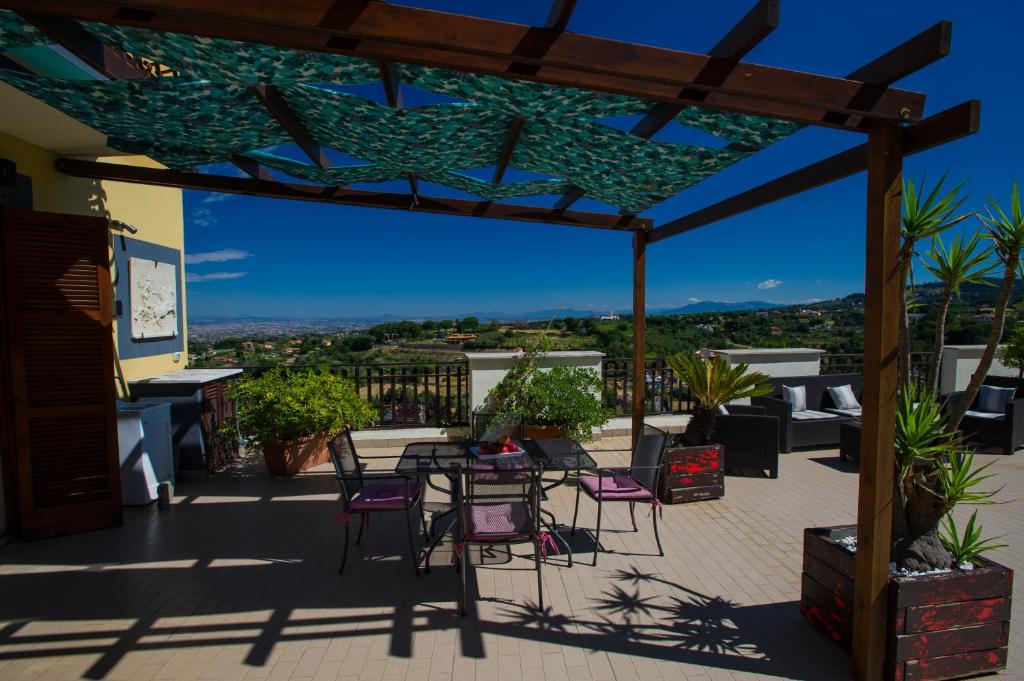 a patio with a table and chairs on a roof at Residence Villa Savoia in Marino