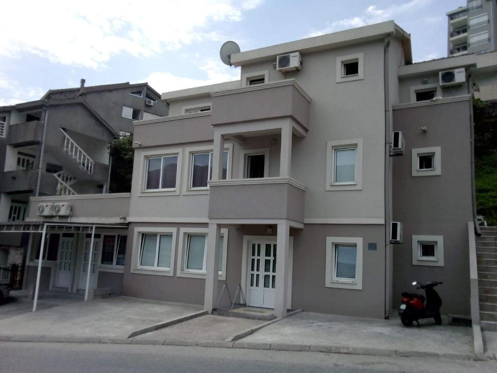 a building with a scooter parked in front of it at Tara Deluxe Apartment in Budva