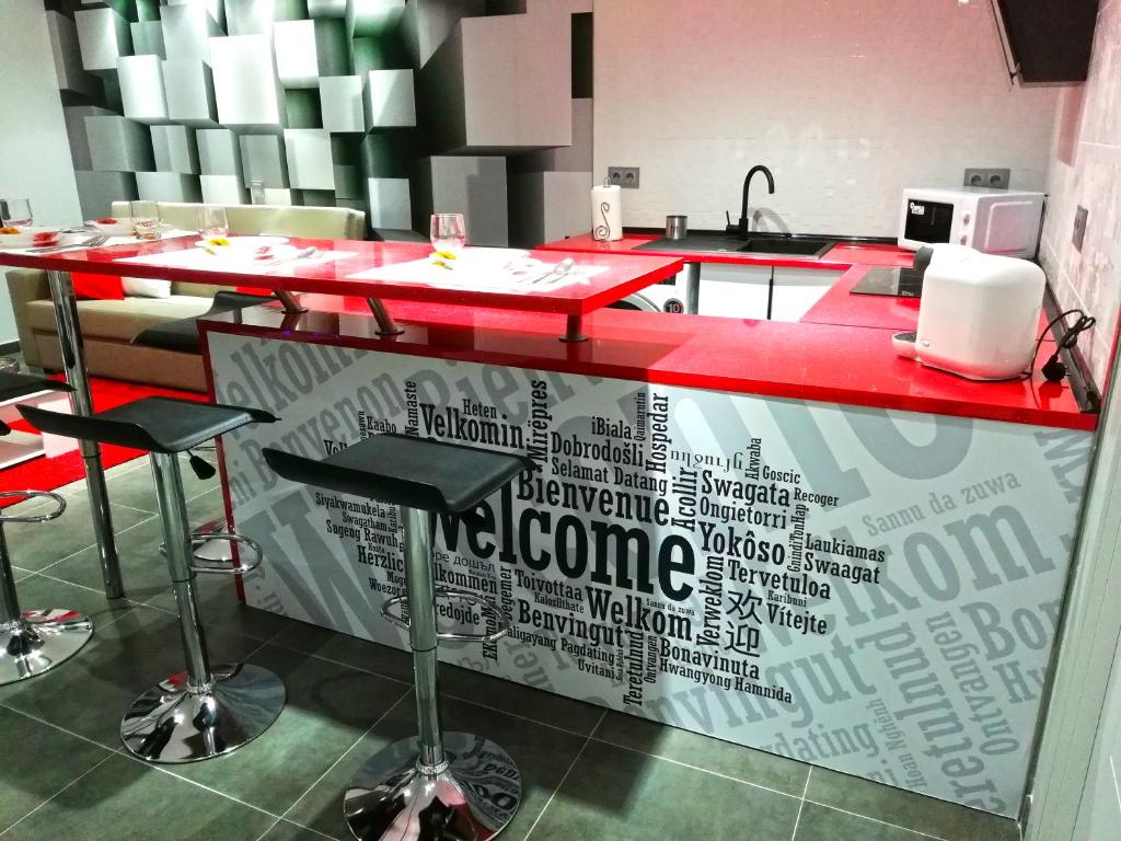 a kitchen with a red counter top with words on it at Los Ángeles Valderrobres in Valderrobres