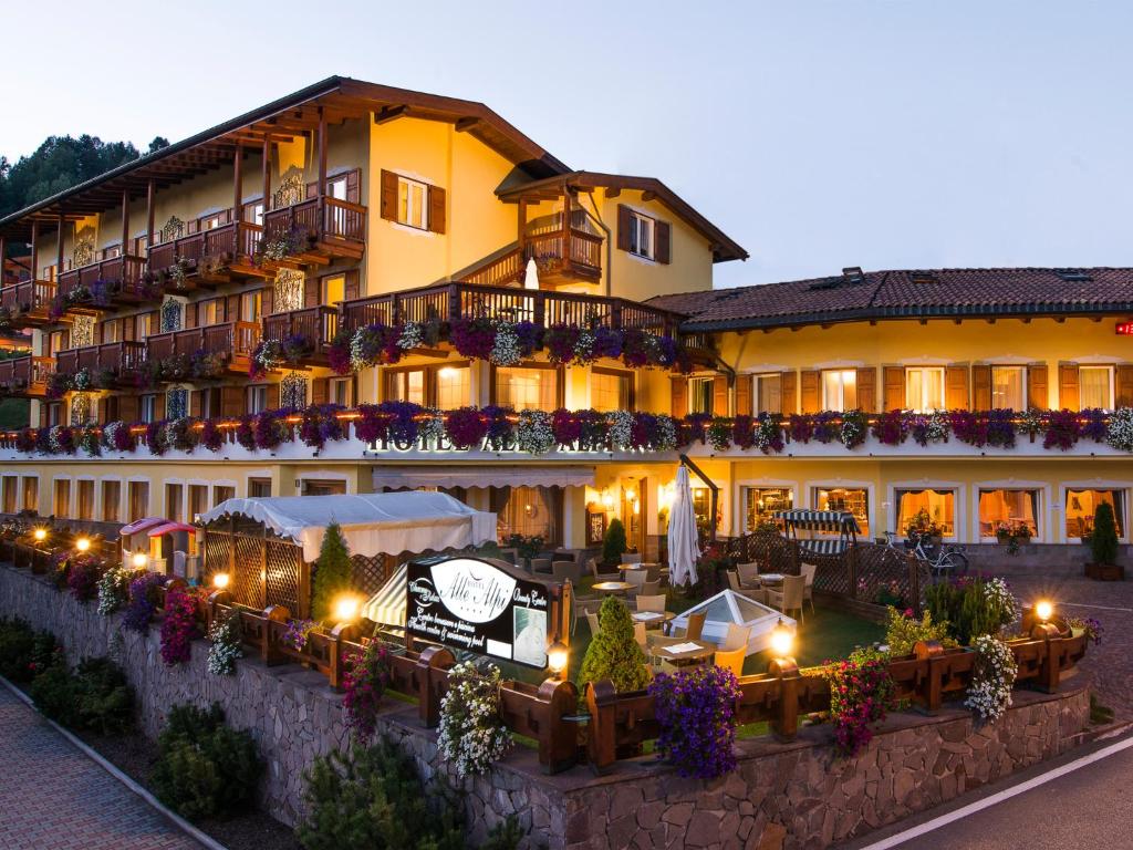 a large building with lights in front of it at Hotel Alle Alpi in Moena