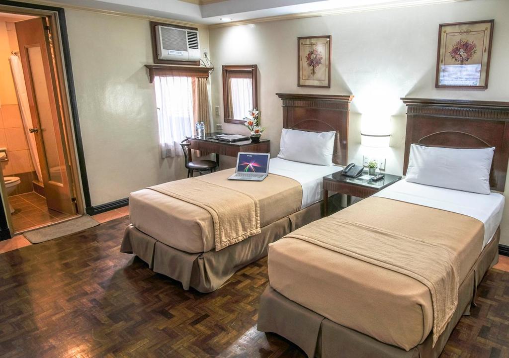 Postel nebo postele na pokoji v ubytování Fersal Hotel - P. Tuazon Cubao