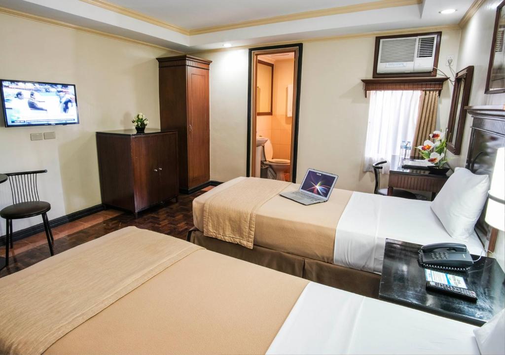 Postel nebo postele na pokoji v ubytování Fersal Hotel - P. Tuazon Cubao