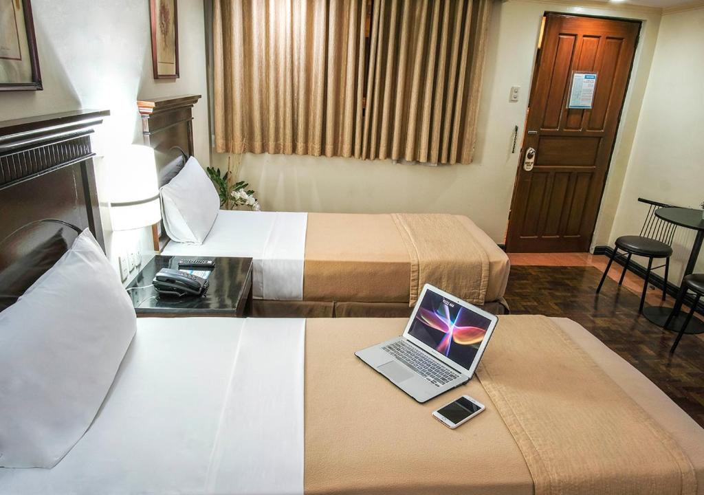 Postel nebo postele na pokoji v ubytování Fersal Hotel - P. Tuazon Cubao